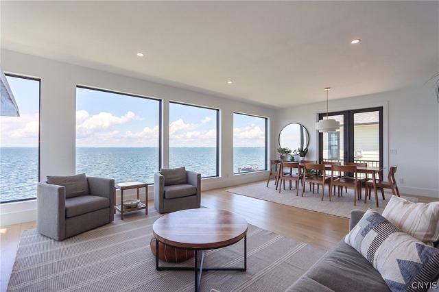 Open living room with floor-to-ceiling lake views